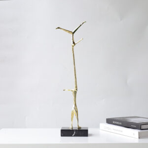 Minimalism gold and black holding human athletic sculpture